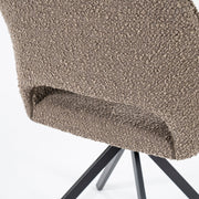 Groene draaistoel in boucléstof met open rug en zwarte trapeziumpoten voor een knusse look aan je eettafel