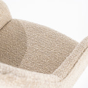 Beige draaistoel met open rug onderaan en zwarte platte stalen poten in een kruisvorm van het merk Eleonora in een knusse teddystof