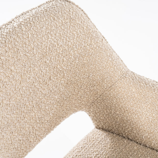 Beige draaistoel met open rug onderaan en zwarte platte stalen poten in een kruisvorm van het merk Eleonora in een knusse teddystof